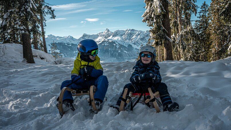 Kinder haben Spaß beim Schlittenfahren auf der Naturrodelbahn Kapell in der Silvretta Montafon | © Silvretta Montafon - Vanessa Strauch